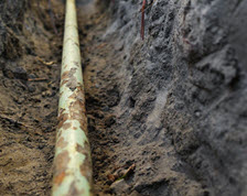 Exposed service line, surrounded by dirt